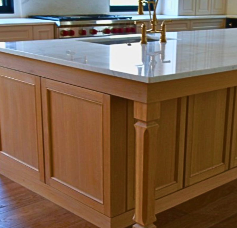 Chef-grade range with marble backsplash and white cabinetry