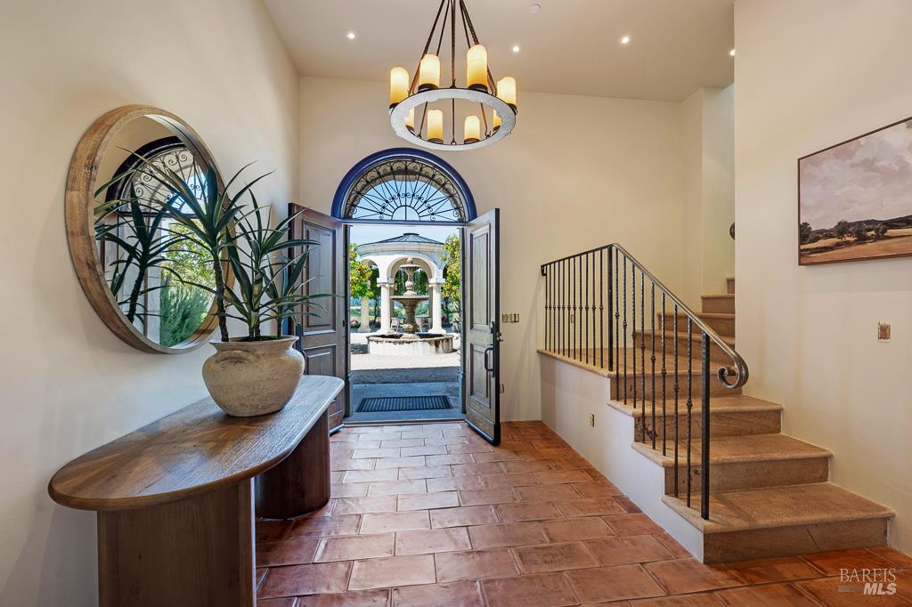 Estate entry with arched doorway and terracotta tile