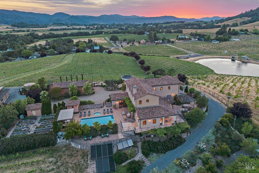 Vineyard estate at sunset with pool and pond